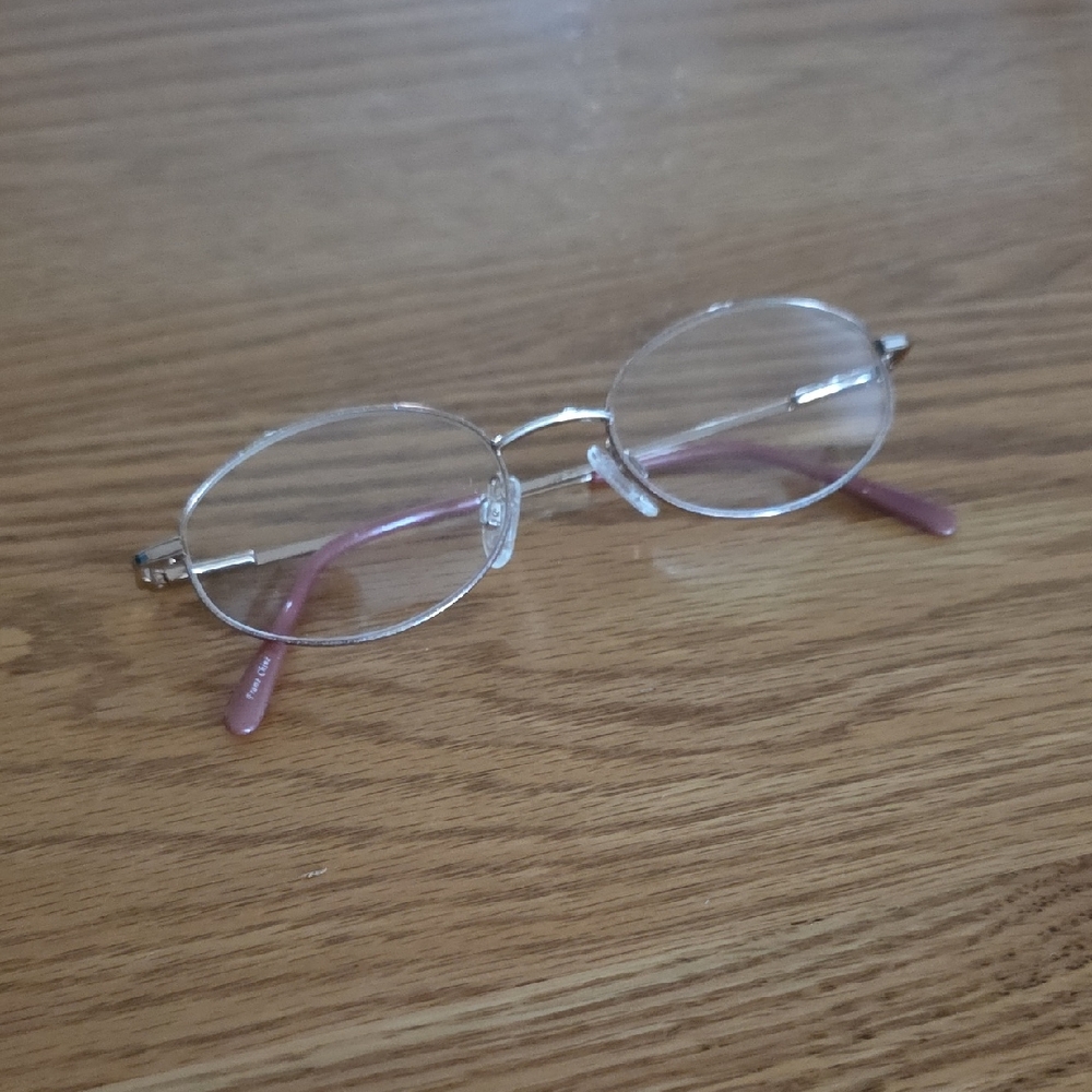 Clear Oval Glasses with Pink And Gold Accents.